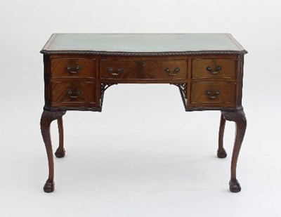 Lot 697 - A George III style leather topped writing desk...