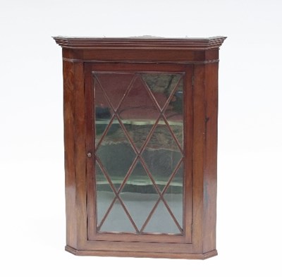 Lot 720 - An early 19th Century mahogany corner cupboard...