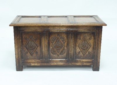 Lot 743 - A carved oak chest and a circular tripod table