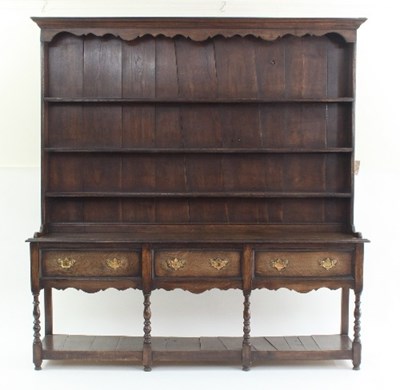 Lot 770 - An oak dresser with shelves over fitted three...