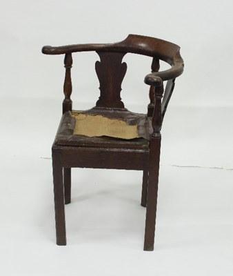 Lot 784 - A George III oak corner chair, with trap seat...