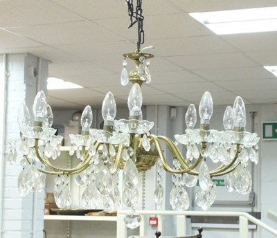 Lot 787 - A twelve-branch gilt metal chandelier, each...