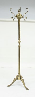 Lot 792 - A brass coat and hat stand on a tripod base,...