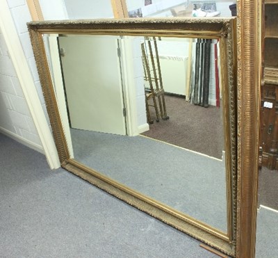 Lot 825 - A large wall mirror with concave gilt frame,...