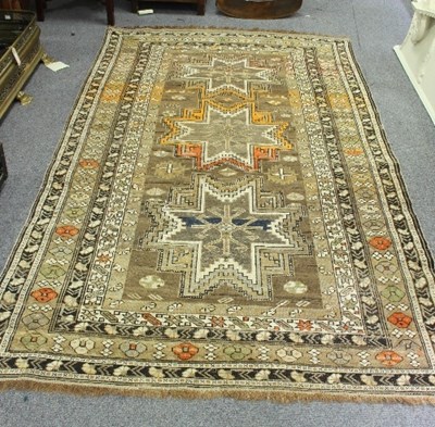 Lot 852 - A Caucasian rug, three medallions on a buff...