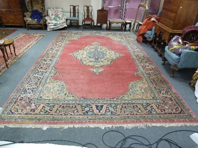 Lot 855 - A large wool carpet, the central blue and...