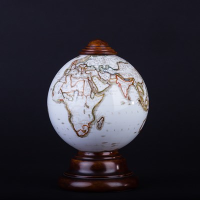 Lot 293 - An opaque white glass world globe, the borders...