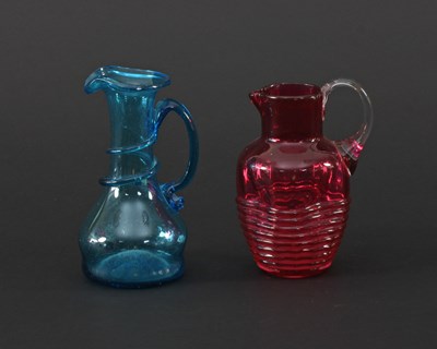 Lot 307 - A blue glass carafe with entwined handle, 16cm...