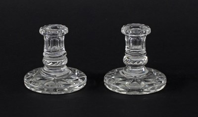 Lot 315 - A pair of cut glass candlesticks on circular...