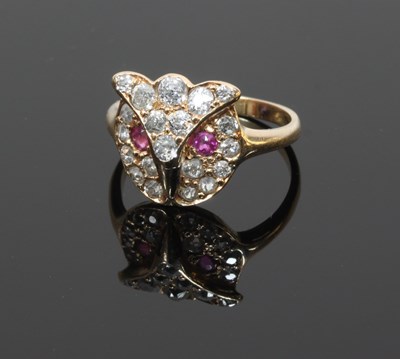 Lot 54 - A ruby and diamond owl-mask ring, the mask set...