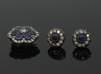 Lot 60 - A sapphire and diamond cluster brooch/pendant,...