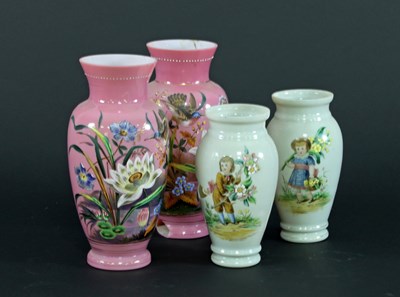 Lot 86 - A pair of opaque pink glass vases enamelled...