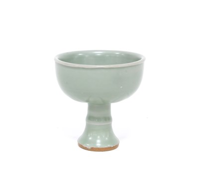 Lot 180 - A Chinese celadon stem cup incised with petals...