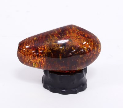 Lot 231 - A large piece of amber, containing vegetable...