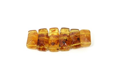 Lot 232 - An amber expanding bracelet, with twelve...