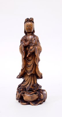 Lot 269 - A Chinese carved figure of Guanyin holding an...