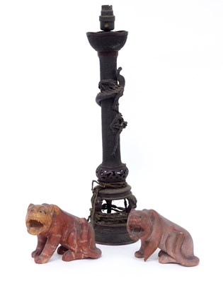 Lot 293 - A Chinese metal lamp stand and two carved...