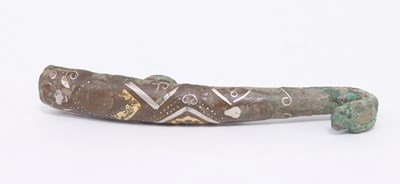 Lot 300 - An early Chinese bronze belt hook with white...