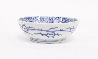 Lot 303 - A Japanese blue and white saucer dish, painted...