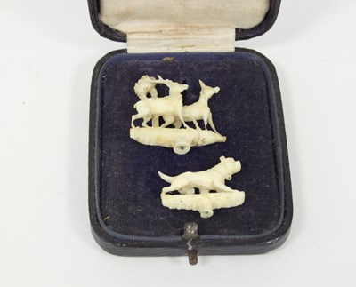 Lot 340 - Two miniature ivory carvings of a mastiff and...