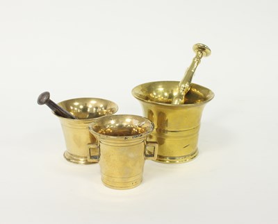 Lot 358 - A brass pestle and mortar, another with iron...