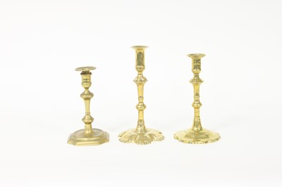 Lot 365 - A George III brass petal based candlestick,...