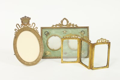 Lot 376 - A gilt brass triple picture frame, on oval...