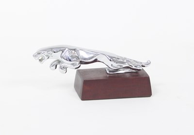 Lot 385 - A chromium plated jaguar car mascot on wooden...