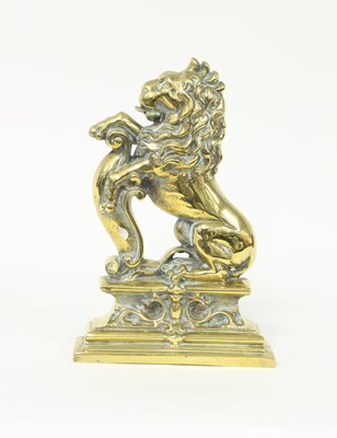 Lot 412 - A 19th Century lion and shield brass door stop,...