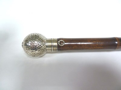 Lot 480 - A golf umbrella, the silver handle of golf...