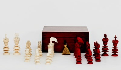 Lot 507 - A red stained and natural ivory chess set by...