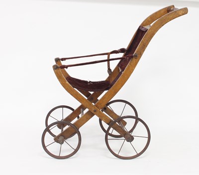 Lot 567 - An Edwardian child's folding pram with plush...