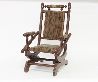 Lot 570 - A doll's American rocking chair with...