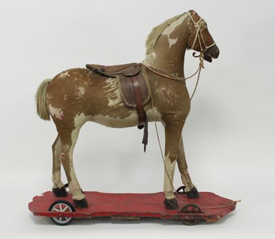 Lot 571 - A child's pull along Victorian Palomino horse,...