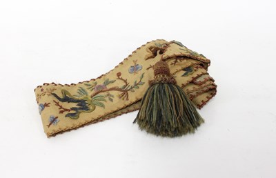 Lot 619 - A wool crewel work bell pull sewn with...