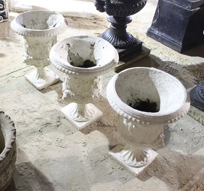 Lot 656 - Three reconstituted stone campana shaped vases,...