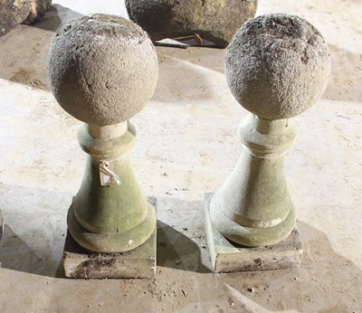 Lot 659 - A pair of baluster columns with ball finials,...