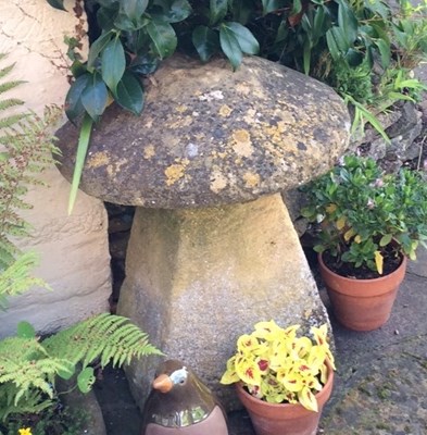 Lot 660 - A staddle stone top on a tapered base, 73.5cm...