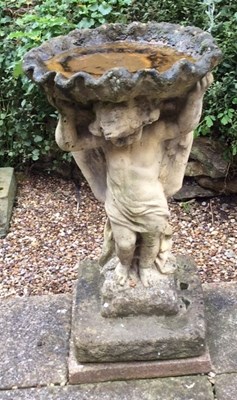 Lot 671 - A reconstituted stone bird bath with scallop...