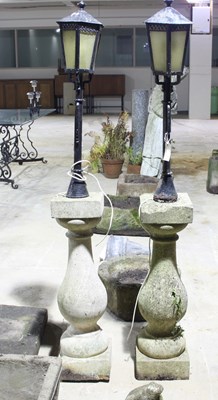 Lot 689 - Two garden lights on baluster columns, 66cm high