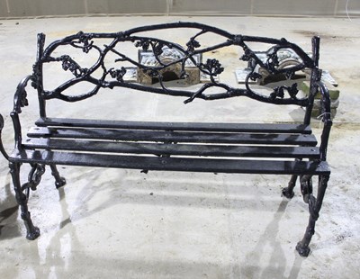 Lot 697 - A cast iron garden chair with interwoven back...