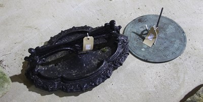 Lot 702 - A quatrefoil cast iron boot scraper and a sundial