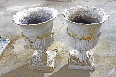 Lot 704 - A pair of cast iron vases with lotus leaf type...