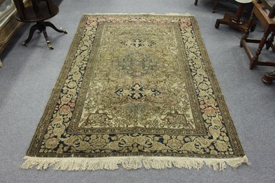 Lot 712 - An Oriental rug with central blue medallion on...