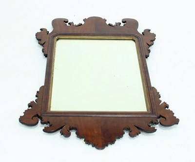 Lot 729 - A George II mahogany fret carved mirror with...