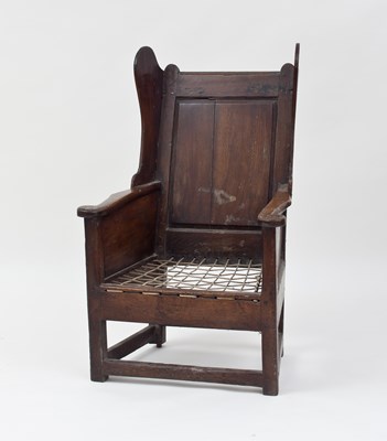 Lot 756 - An 18th Century oak lambing chair with wing...