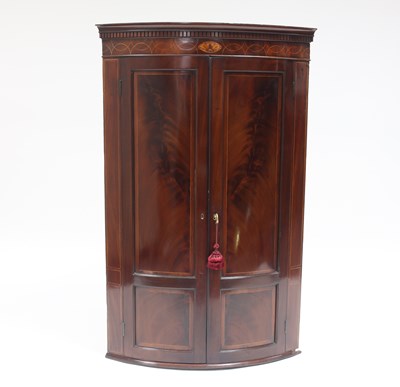 Lot 810 - An early 19th Century mahogany bowfront corner...