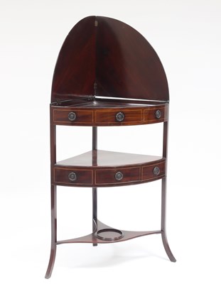 Lot 811 - A George III mahogany bowfront corner...