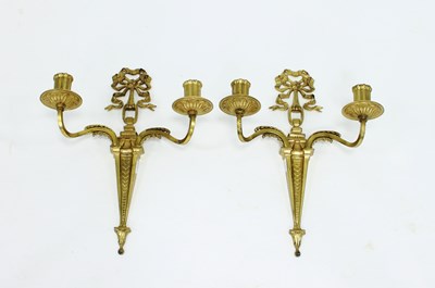 Lot 824 - A pair of gilt metal two-light wall lights...