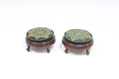 Lot 853 - A pair of Victorian walnut circular footstools...